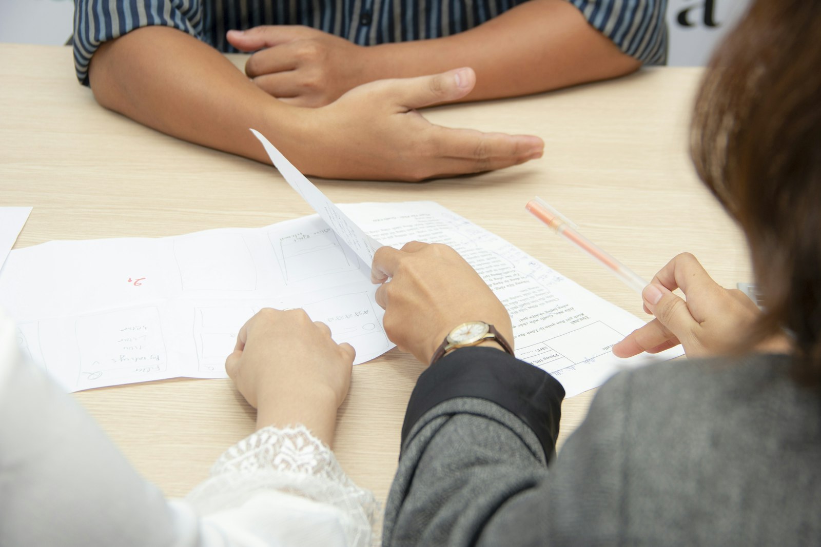 Professionals reviewing property valuation documents for a divorce appraisal with 3:16 Appraisals