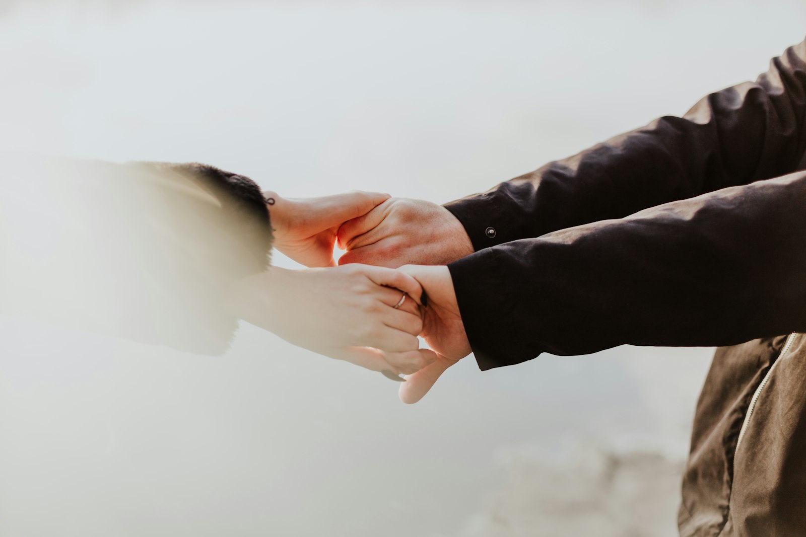 Two people holding hands in comfort and support during an estate and date of death appraisal with 3:16 Appraisals